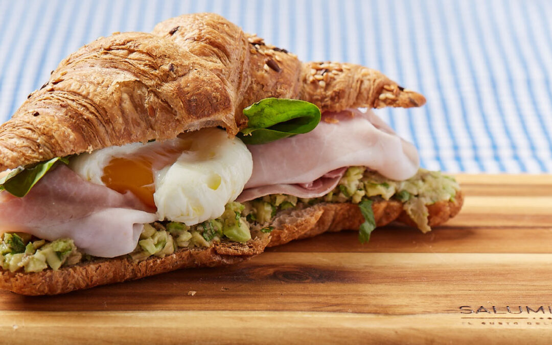 Salted croissant  with cooked ham, guacamole and egg