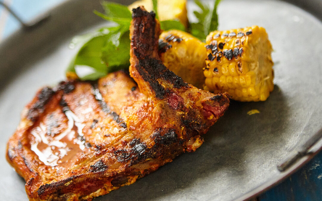 Marinated pork chops with yoghurt and spices and corn