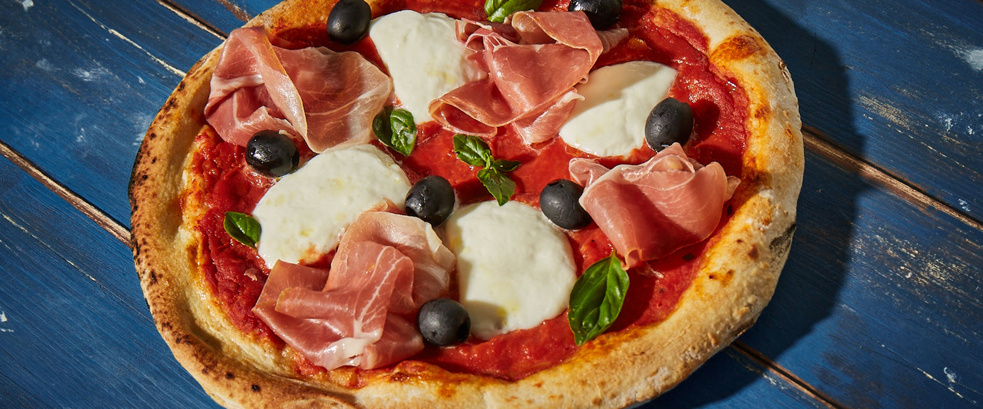 Pizza with Cured Ham, La Rustica Tomato Sauce, Buffalo Mozzarella, Olives and Basil