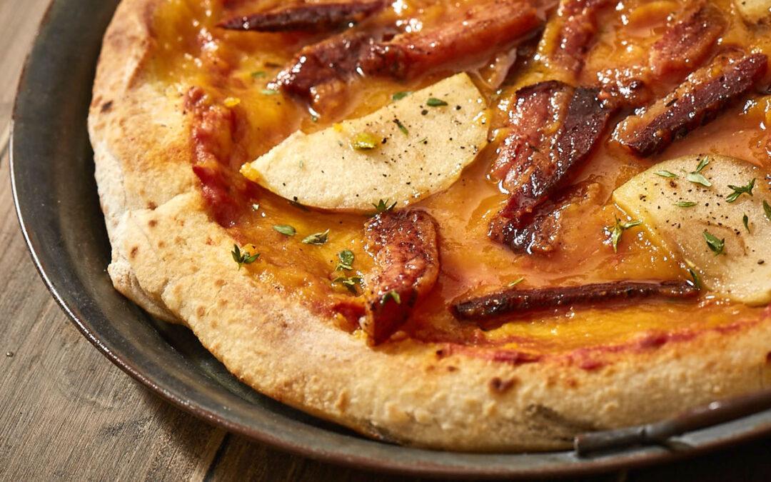 Pizza with bacon, pumpkin and apples